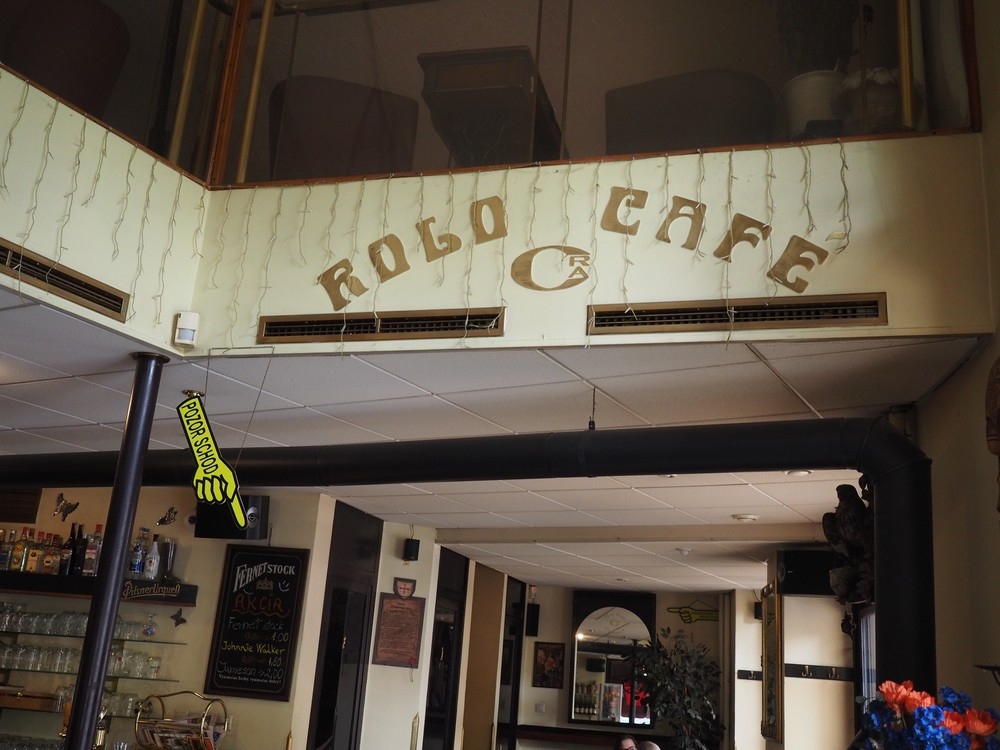 Útulný kút interiéru Rolo Café s rastlinami a dekoráciou